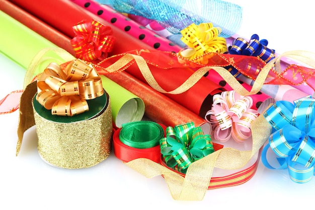 Rolls of Christmas wrapping paper with ribbons, bows isolated 