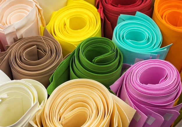 Rolls of colored paper - green, brown, blue, pink, orange, red, white. Soft focus