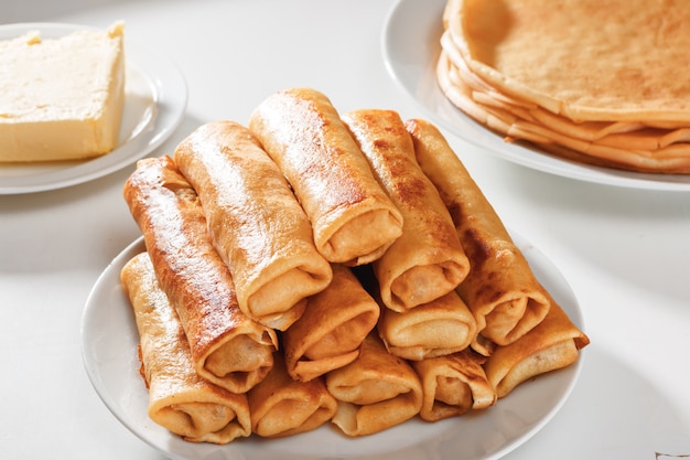 Rolls of pancakes with meat are on plate