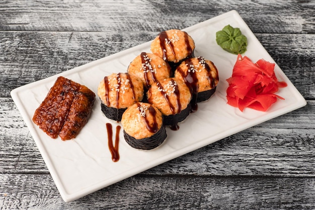 Rolls sushi sushi with fish on a wooden white background