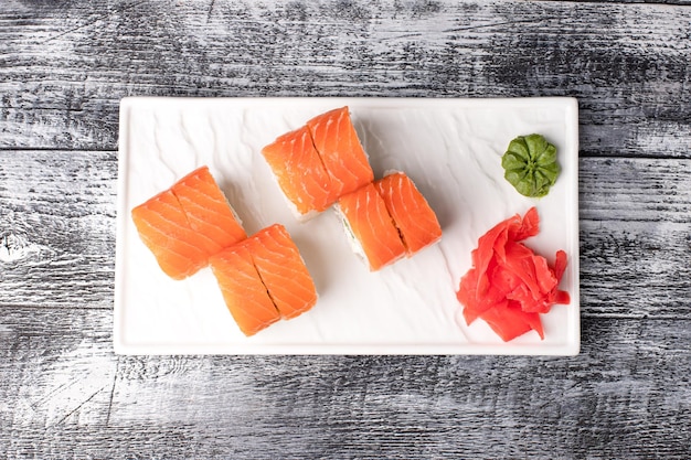 Rolls sushi sushi with fish on a wooden white background