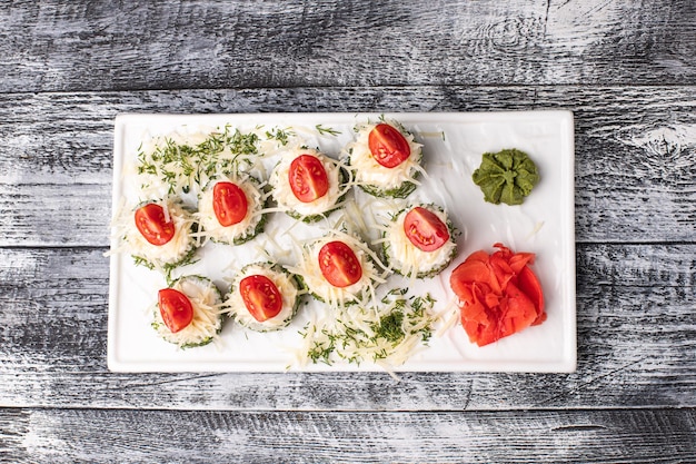 Rolls sushi with fish on a white wooden background