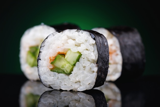 Rolls with cucumber on a black background