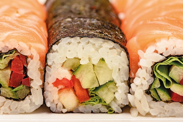 Rolls with salmon noori seaweed rice and vegetables Delicious Japanese cuisine