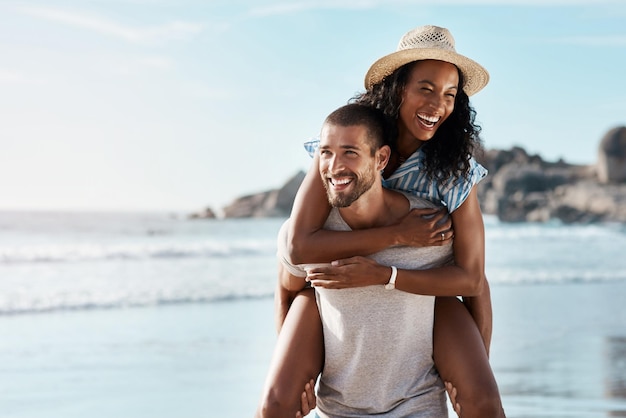 Romance ocean and piggy back happy couple with blue sky on romantic summer holiday travel to beach Love man and woman at sea happiness on date and romantic adventure vacation together in Mexico