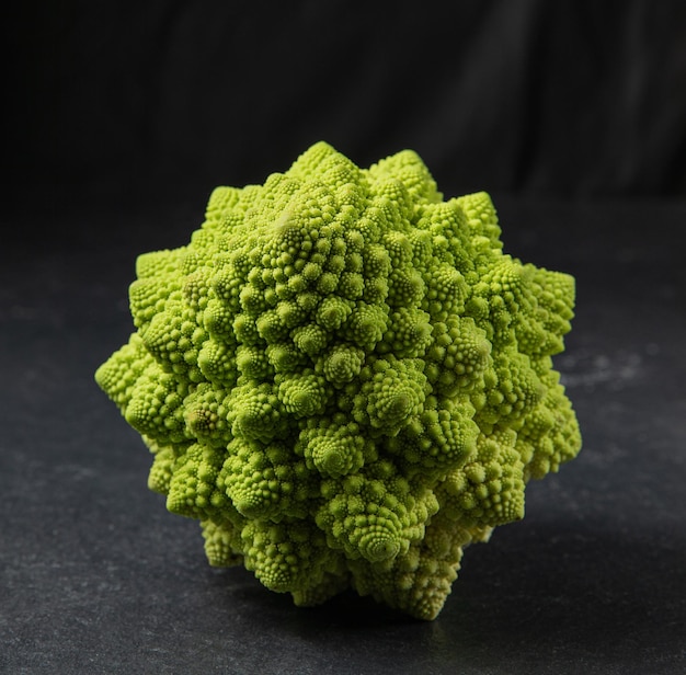 Romanesco broccoli head on a dark stone surface cabbage close up fibonacci sequence for those who love mathematics