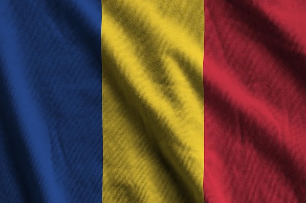 Romania flag with big folds waving close up under the studio light indoors The official symbols and colors in banner