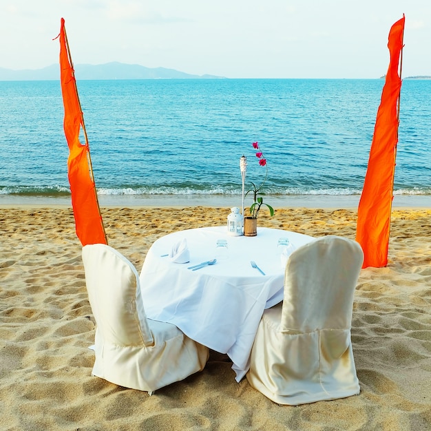 Romantic beach restorant at tropical resort. Dating on the beach