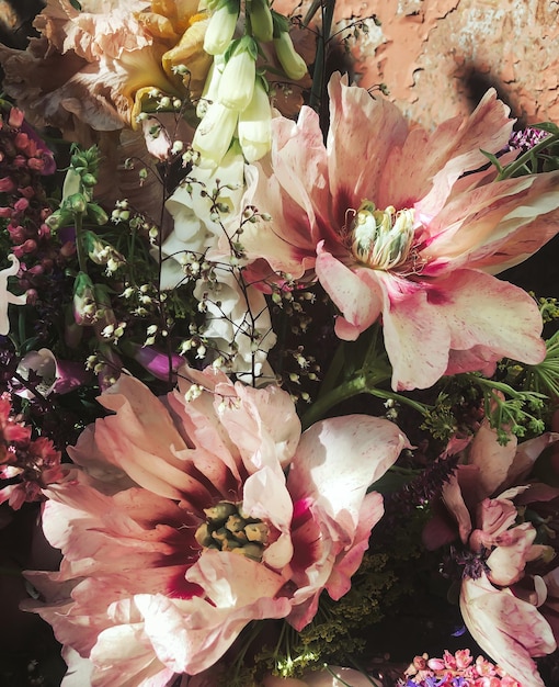 Romantic bouquets of spring flowers with peonies sage foxglove geyhera