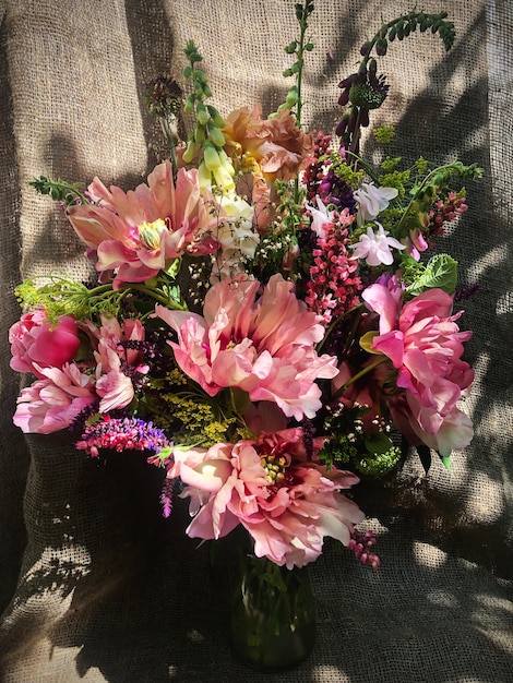 Romantic bouquets of spring flowers with peonies sage foxglove geyhera