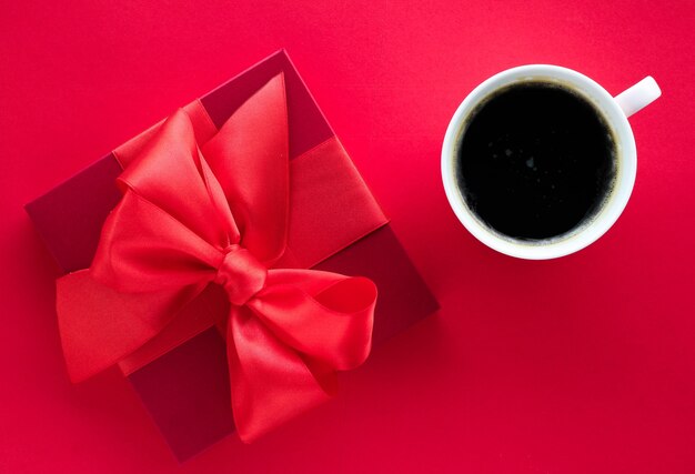 Romantic celebration lifestyle and birthday present concept  luxury beauty gift box and coffee on red flatlay