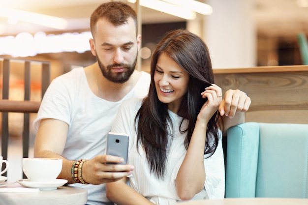 romantic couple dating in cafe and taking selfie