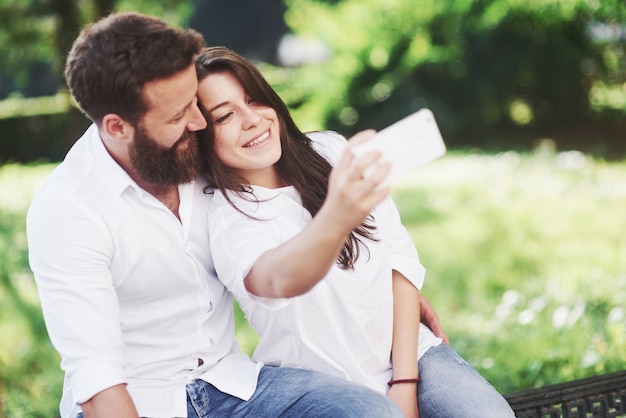 Romantic couple enyojing in moments of happiness in the park. Lifestyle concept love and tenderness