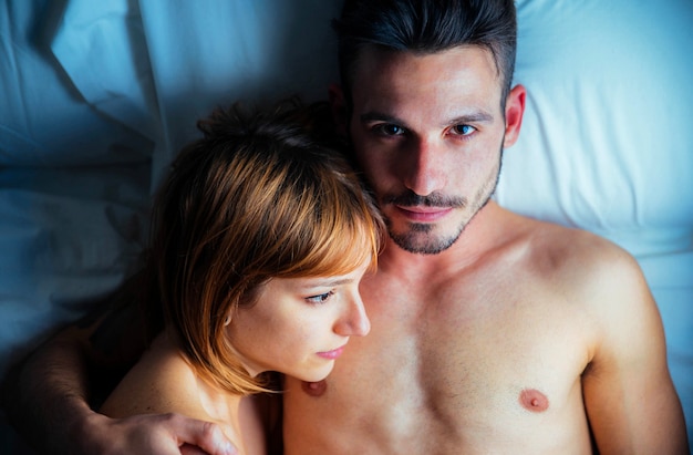 Romantic couple in love lying on the bed together