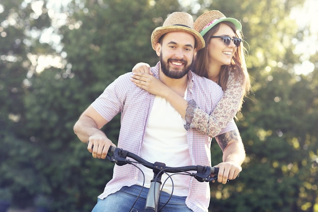 romantic couple riding bikes in forest