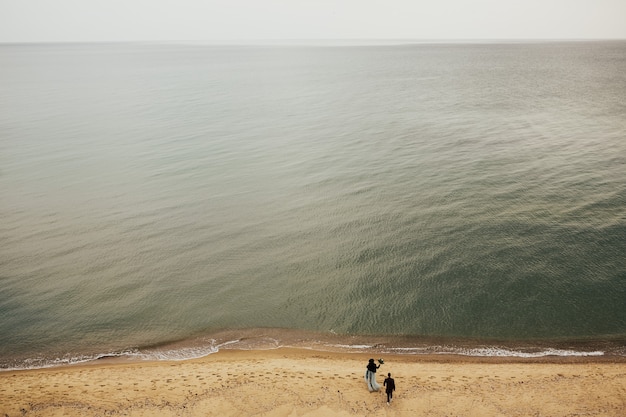 Romantic couple on the sandy beach. Azure water.