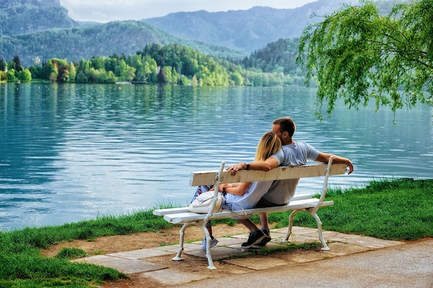 Romantic couple sitting on the bench at Bled Lake, Slovenia