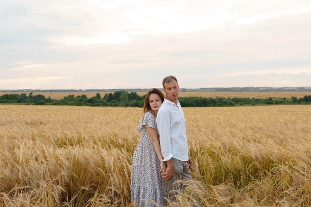 Romantic date on summer meadow love couple hugs