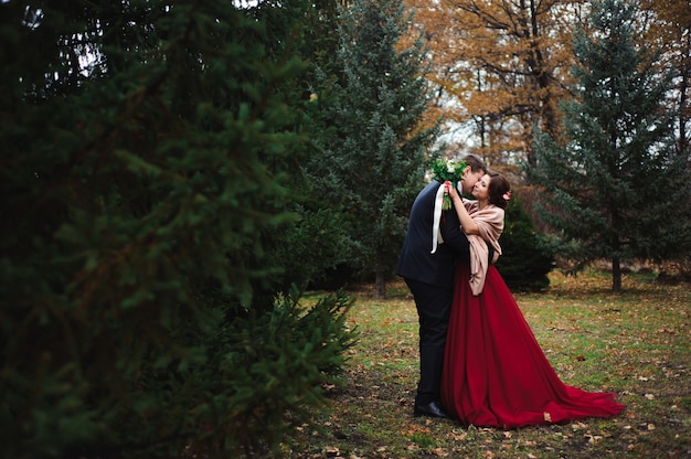 Romantic embrace of newlyweds. Couple walks in the park.