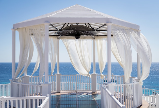 Romantic gazebo on the beach with blue sea