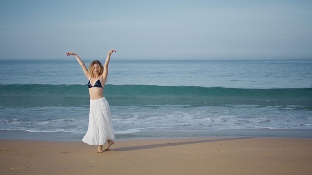 Romantic girl performing dance on beautiful sand beach choreographer dancing