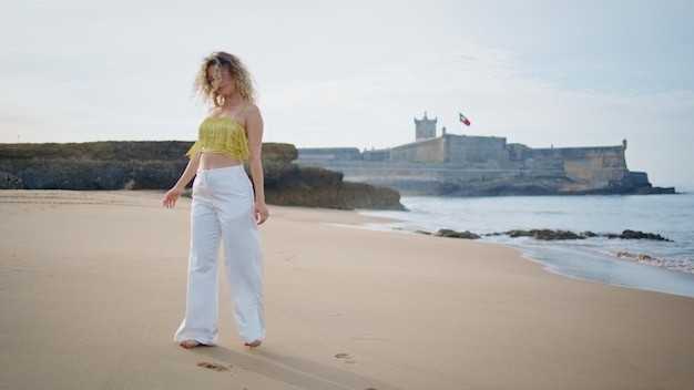 Romantic girl walking seashore summer weekend carefree woman strolling beach