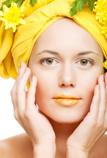 Romantic image of a young woman with yellow chrysanthemums