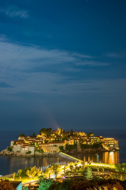 Romantic island of Sveti Stefan glow in the night with the moonlight