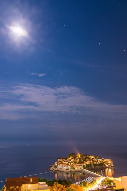 Romantic island of Sveti Stefan glow in the night with the moonlight