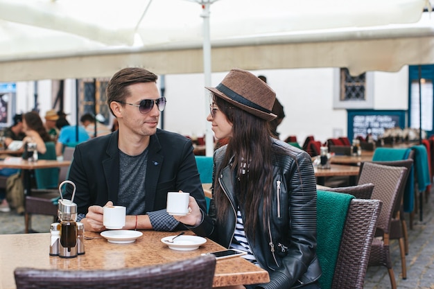 Romantic loving couple drinking coffee having a date in the outdoor cafe