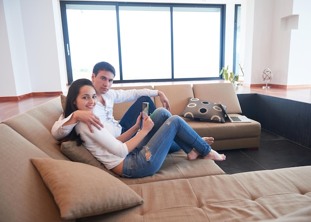 romantic relaxed young couple at modern home using tablet computer