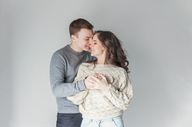 Romantic sexy couple in love having nice time together Young woman hugging boyfriend white background