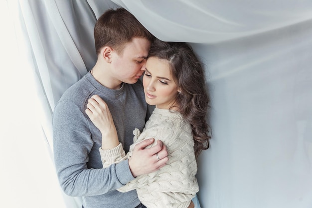 Romantic sexy couple in love having nice time together Young woman hugging boyfriend white background