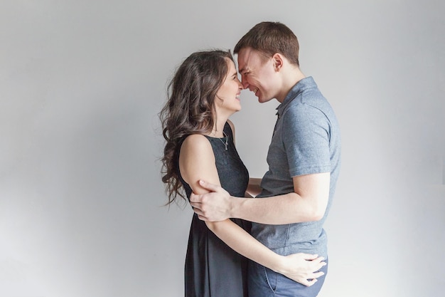 Romantic sexy couple in love having nice time together Young woman hugging boyfriend white background