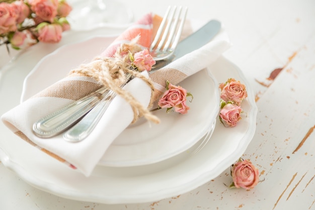 Romantic table setting with died flowers