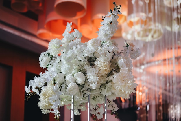 Romantic Wedding Table Top Layout Decor with large lush floral bouquets including white roses ranunculus persian buttercups white orchids and candles