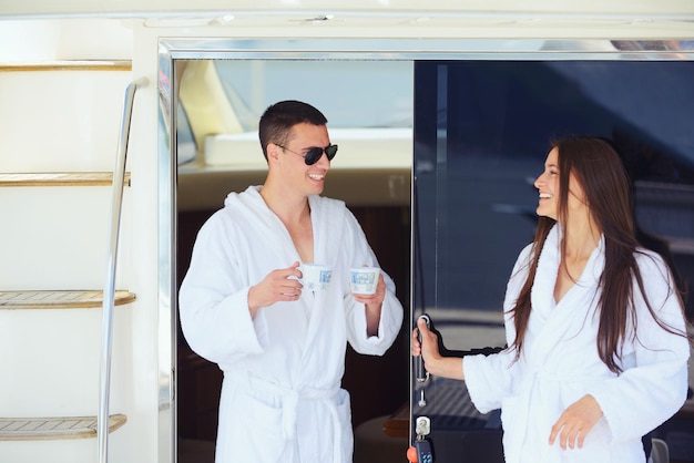 Romantic young couple spending time together and relaxing on yacht