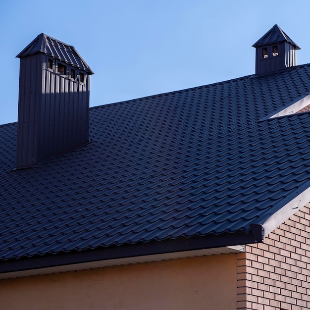 The roof is made of brown metal tiles.