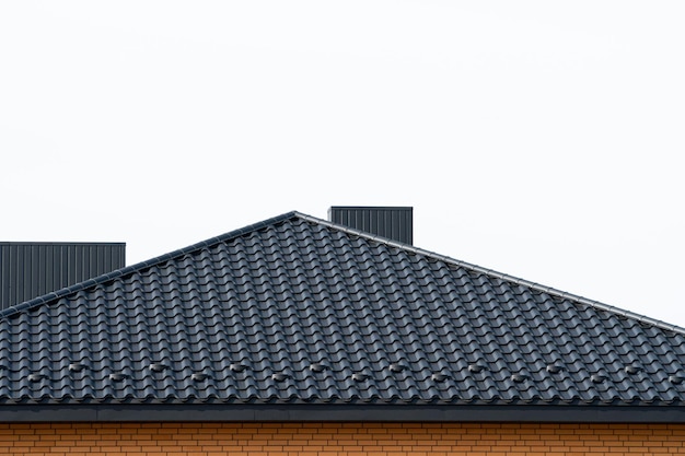 Roof structure covered with black metal tiles Modern types of roofing materials Modern housing