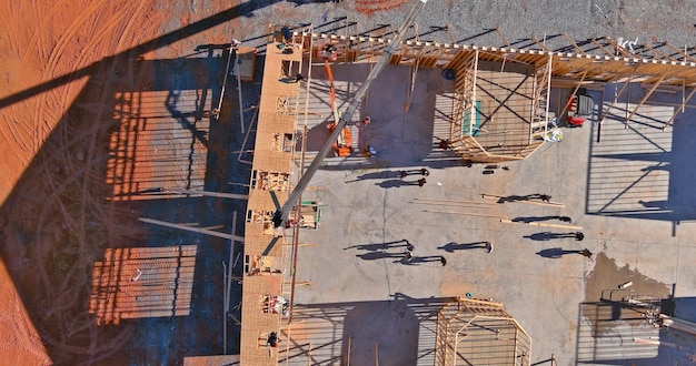 Roofer working with framing installing the roof truss wood workers nailing wood beams