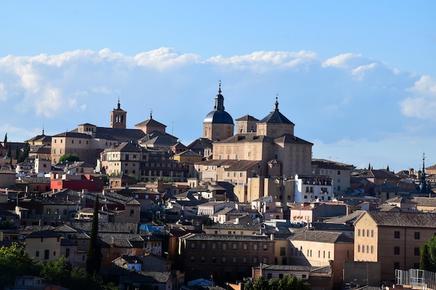 Rooftops and landscape of Toledo the ancient city, architectural buildings, blue sky and clouds