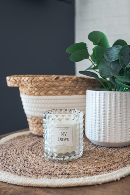 Room decor candle green plant and wicker basket closeup interior details