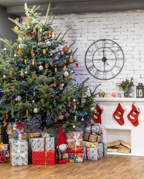 Room interior with beautiful Christmas tree gift boxes and decorative fireplace