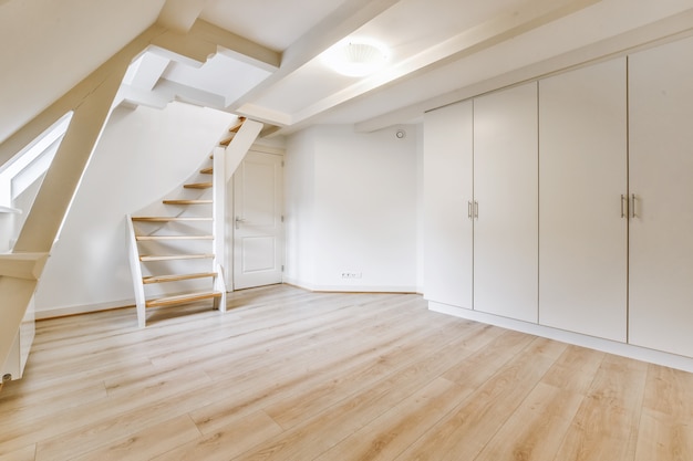 Room with big wardrobe and stylish staircase