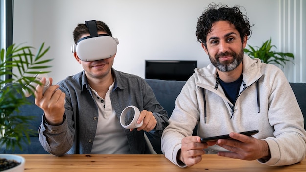 Roommates sitting at table in living room and watching virtual reality vision