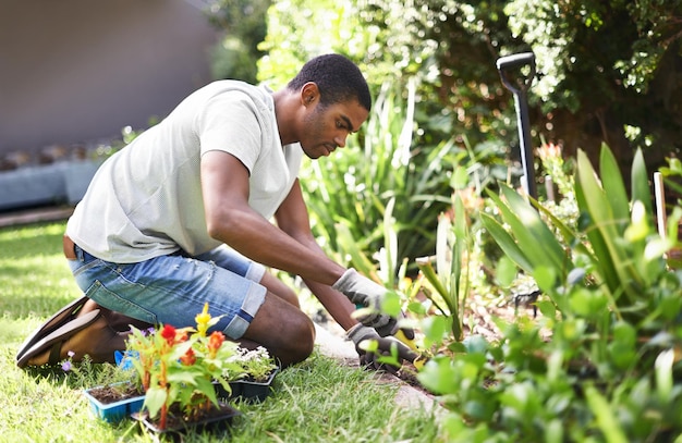 Rooting out the problem Cropped shot of a handsome young man gardening