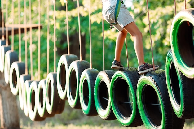 Rope park. A boy passes an obstacle on tires in a rope Park.