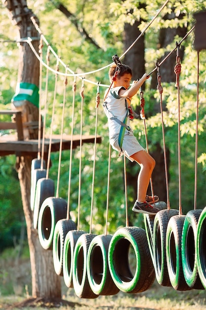 Rope park. A boy passes an obstacle on tires in a rope Park.