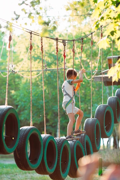 Rope park. A boy passes an obstacle on tires in a rope Park.