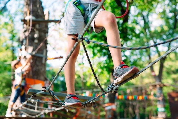 Rope Park. close - up of a child's feet passing an obstacle.